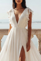 Load image into Gallery viewer, Ivory Ruffled V-Neck Ruched A Line Sweep Train Beach Wedding Dress with Slit